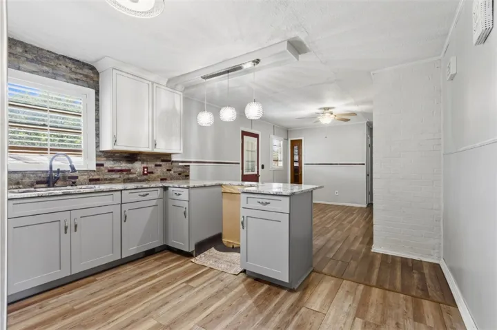 This updated kitchen offers ample counter space and a new refrigerator.