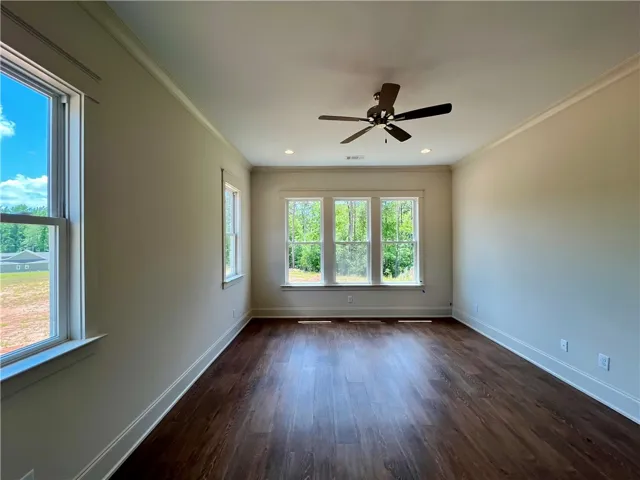 Primary bedroom has ample natural light &  view of natural greenspace.