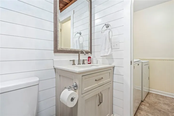 A well-appointed bathroom vanity with a crisp white countertop and shiplap walls.