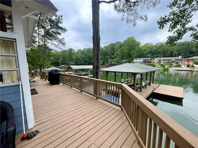 A spacious wooden deck provides direct access to the lake, complete with a private boat dock and covered slip.