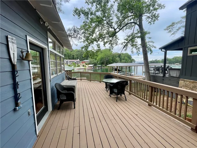 A spacious outdoor deck offers tranquil views of the water and surrounding landscape.