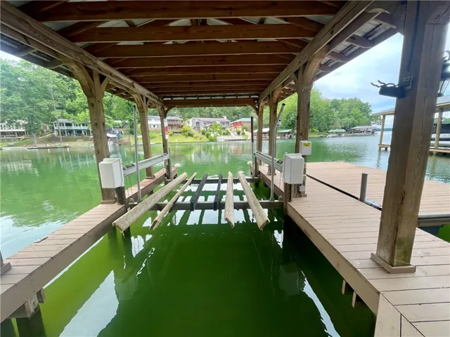 A private boat slip with a sturdy dock awaits on the shimmering lake.
