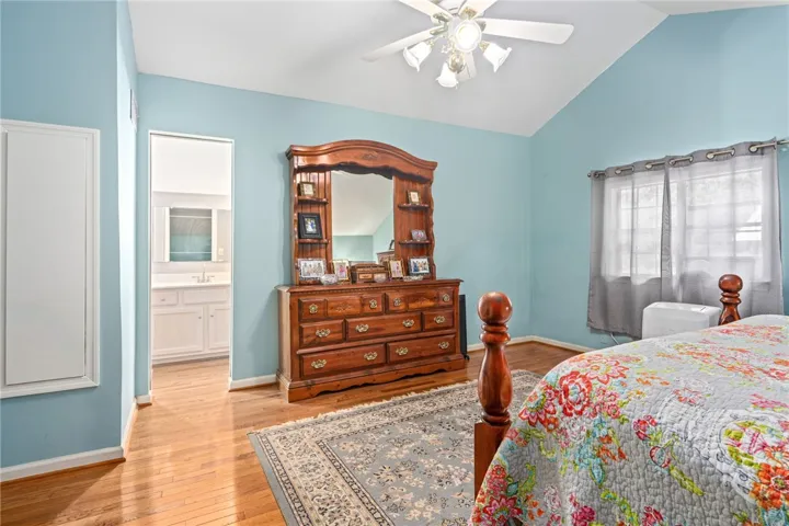 Hardwood floors and a vaulted ceiling elevate this comfortable sleeping space with an ensuite bath.
