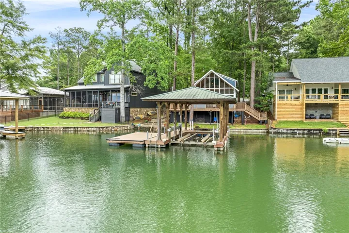 Lakeside residences boast an inviting covered boat dock and serene water frontage.