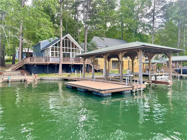 This lakeside home offers expansive deck space and a private dock for waterfront enjoyment.