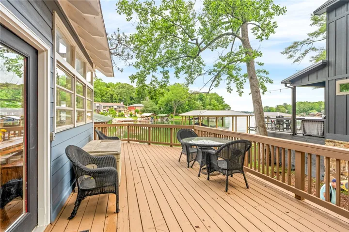 A spacious wooden deck provides ample room for outdoor enjoyment with serene waterfront views.