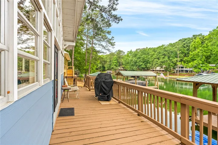 A spacious wooden deck provides direct lake access and captivating water views.