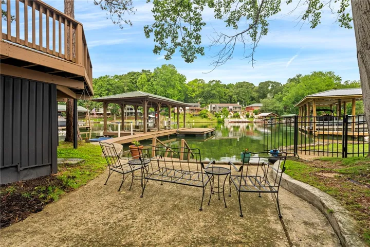 A tranquil lakefront property featuring private docks and a concrete patio.