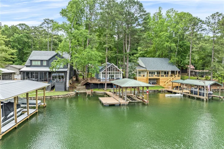 Lakeside living beckons with multiple boathouses, inviting decks, and a captivating waterfront.