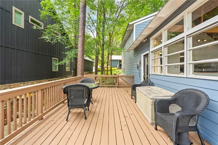 A spacious wooden deck extends along the home, perfect for outdoor relaxation and entertaining.