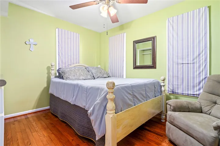 Warm hardwood floors and a spacious feel define this inviting bedroom retreat.