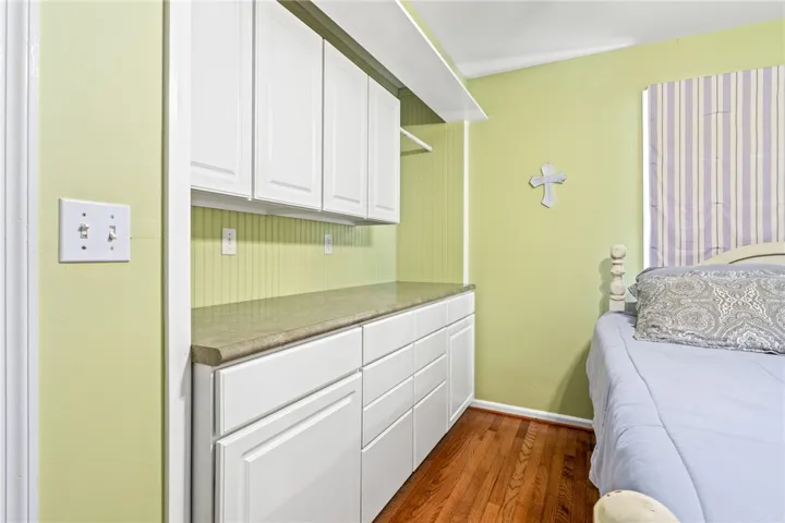 Custom cabinetry and hardwood flooring enhance the cozy appeal of this bright room.