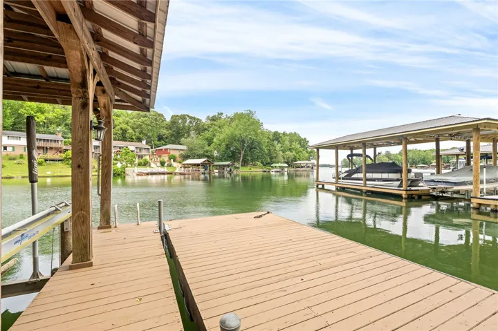 A spacious private dock awaits, providing direct access to the glistening lake and scenic surroundings.
