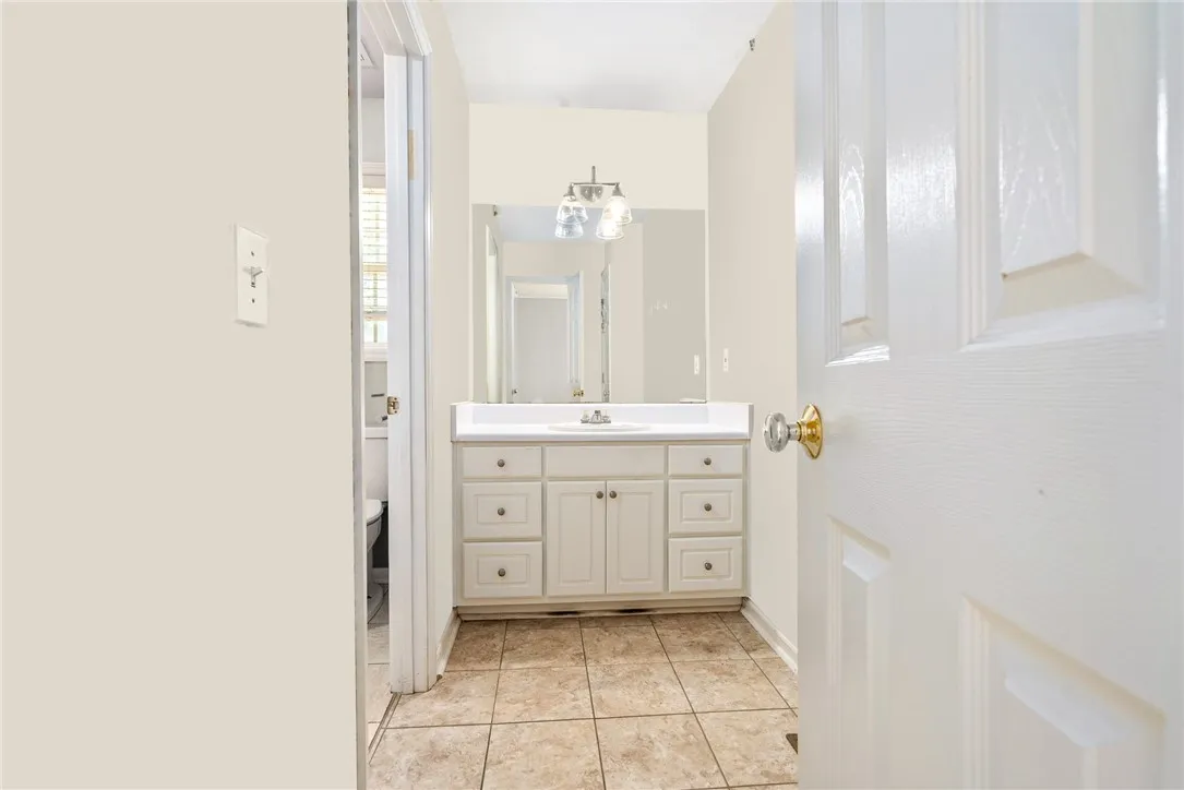 A well-appointed bathroom offers a vanity with ample storage and a clear mirror.