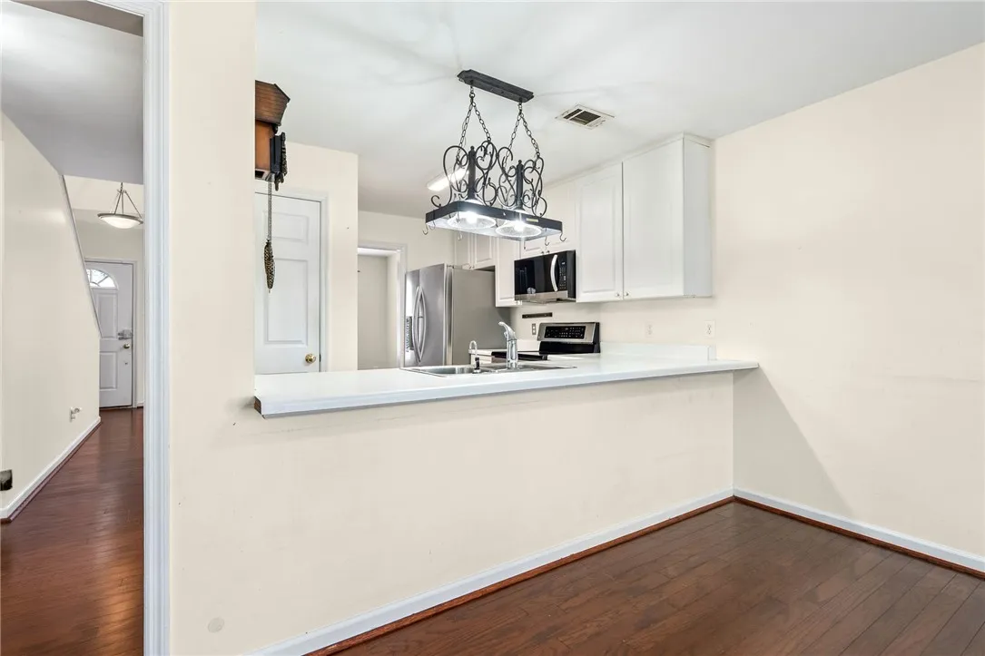 A streamlined kitchen layout with a breakfast bar seamlessly connects to adjacent living spaces.