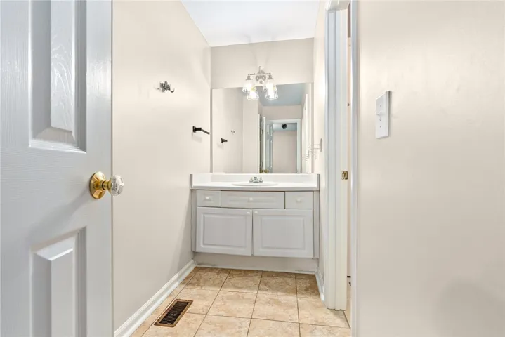 Functional vanity and mirror create a clean and welcoming powder room.