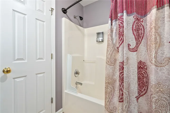 Step into this private bath featuring a combined tub and shower for refreshing convenience.