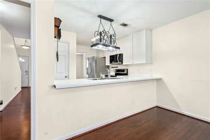 A streamlined kitchen layout with a breakfast bar seamlessly connects to adjacent living spaces.