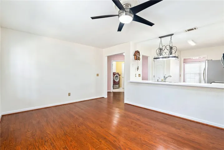 This living area features a bright and open layout with rich hardwood floors.