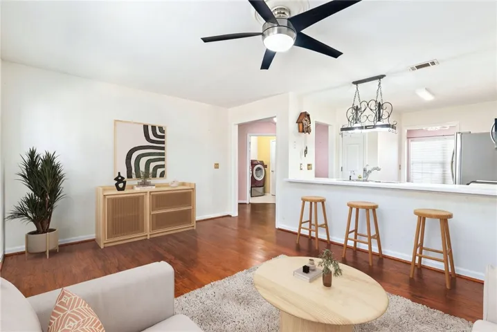 This inviting space features an open concept, connecting the living area with a functional kitchen.