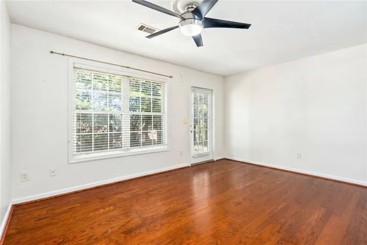 This bright space features gleaming hardwood floors and ample natural light through large windows.