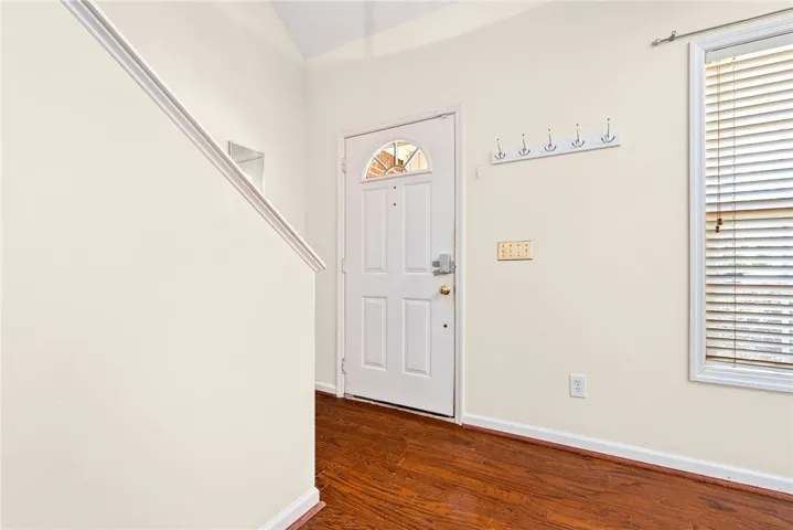 A welcoming entry offers rich wood flooring, leading guests into this comfortable residence.