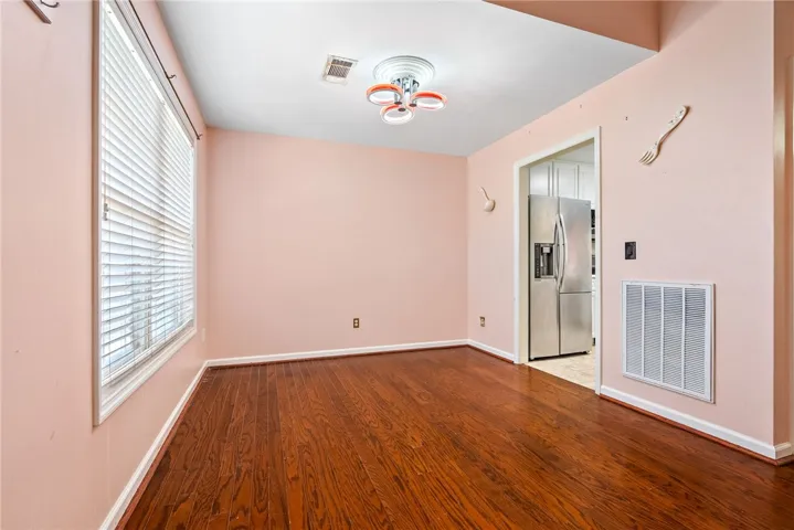 This versatile space offers beautiful hardwood floors and convenient access to the adjacent kitchen.