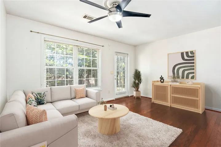 This airy living space features abundant natural light, offering a welcoming atmosphere for daily living.