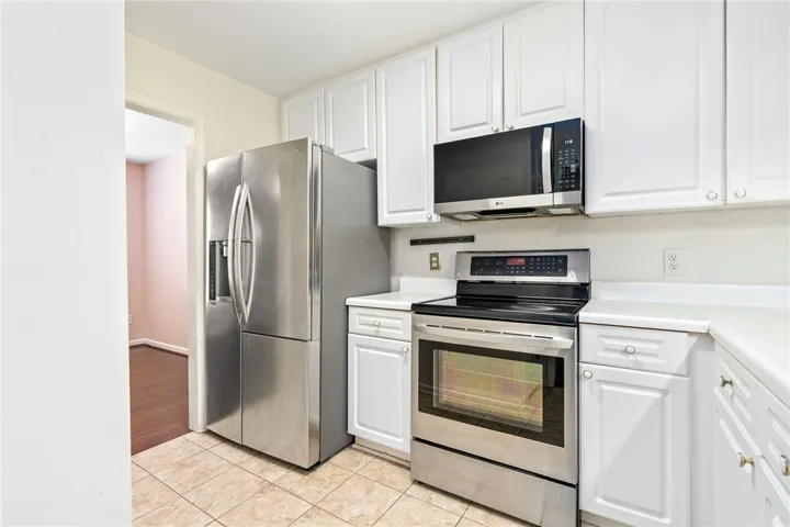 This functional kitchen features stainless steel appliances and ample cabinetry.