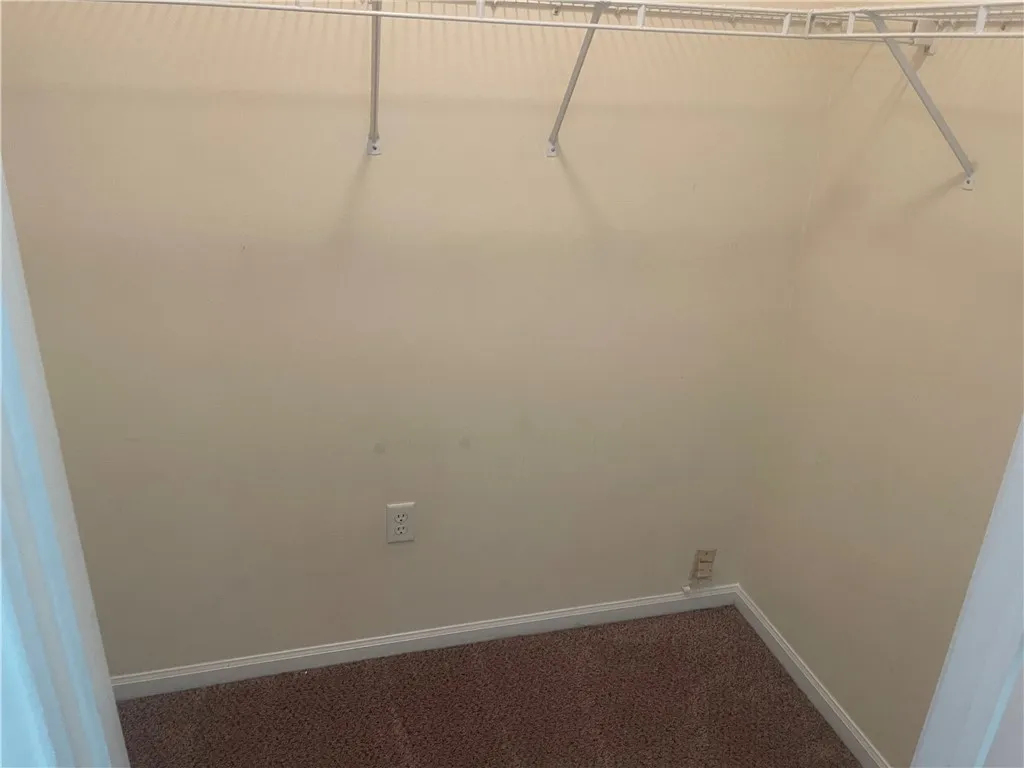 This spacious walk-in closet offers ample storage potential for your wardrobe and belongings.