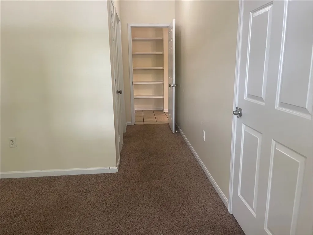 This interior hallway features convenient closet space, perfect for organization and storage.