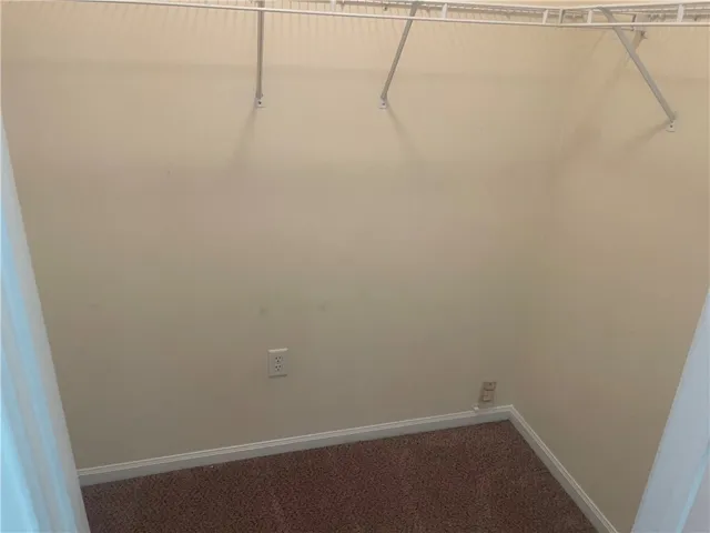 This spacious walk-in closet offers ample storage potential for your wardrobe and belongings.
