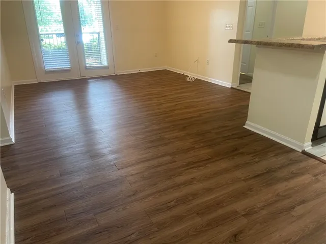 This inviting space features durable flooring, offering a seamless flow to the exterior with abundant natural light.