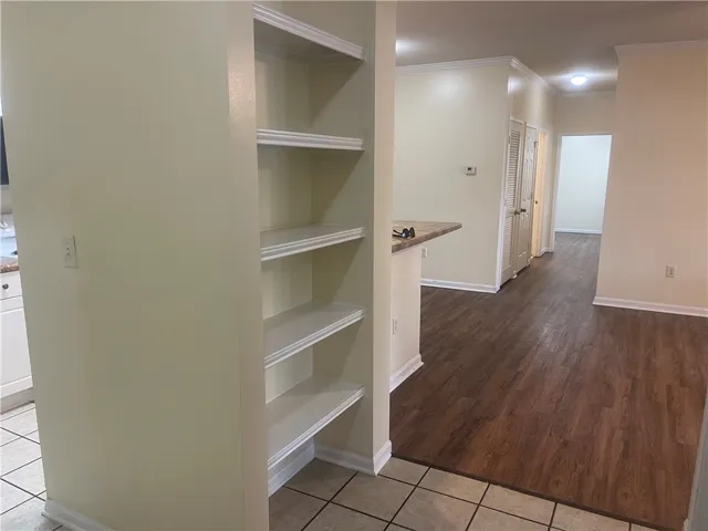 This inviting interior features elegant flooring and built-in shelving, perfect for organized living.