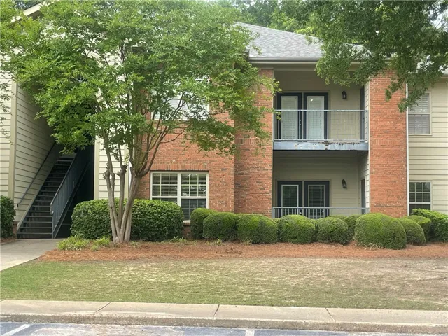 This charming multi-story building offers inviting balconies and convenient exterior stair access.