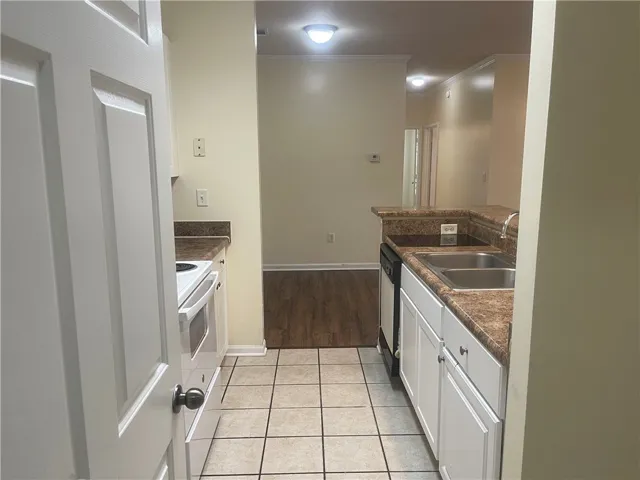 This kitchen features ample counter space and appliances, ready for your culinary endeavors.