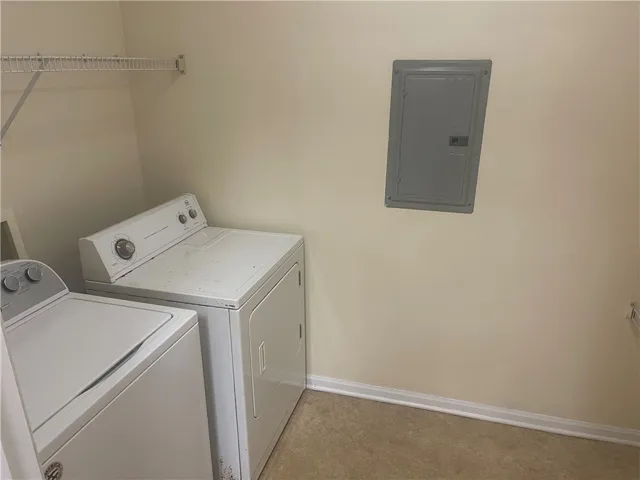 This dedicated space includes a washer and dryer for effortless daily routines.