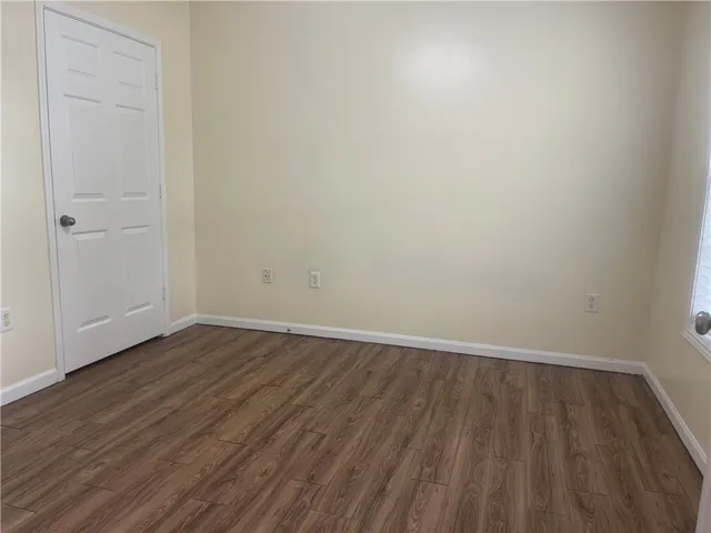 This versatile room features durable flooring and ample natural light, ideal for a flexible living space.