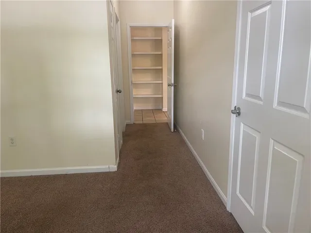 This interior hallway features convenient closet space, perfect for organization and storage.