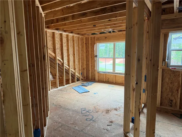 Exposed wood framing and subfloors highlight the layout of this under-construction space.