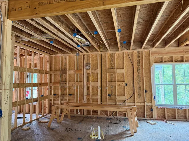 Exposed framing and structural beams define this home currently under construction.