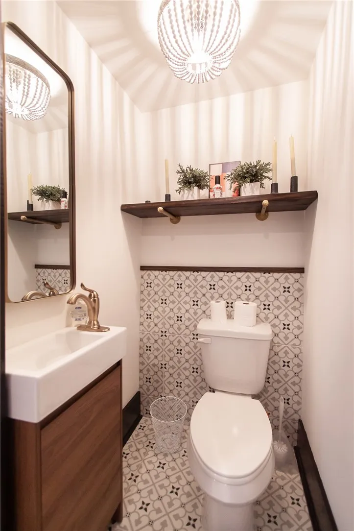 This powder room features elegant tile work and a stylish vanity, perfect for guests.