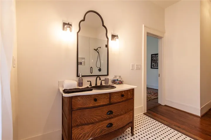 This primary bathroom offers a unique blend of traditional and modern elements, perfect for daily routines.