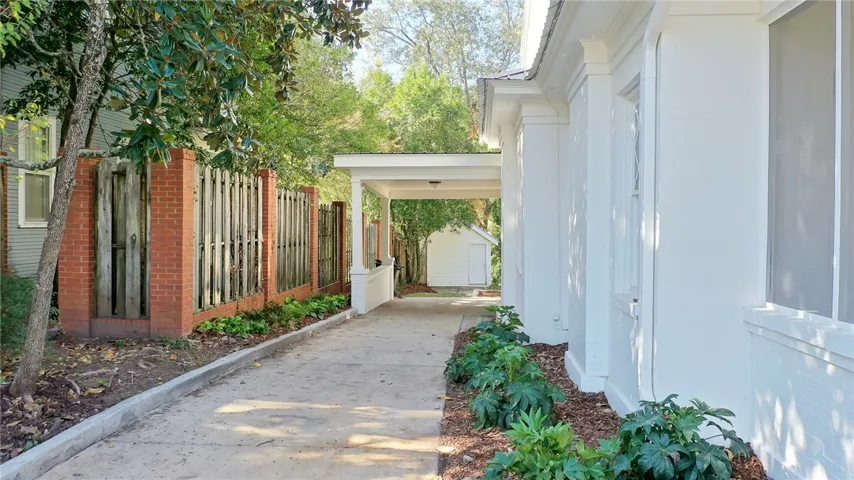This residence features a long driveway leading to a private detached structure.