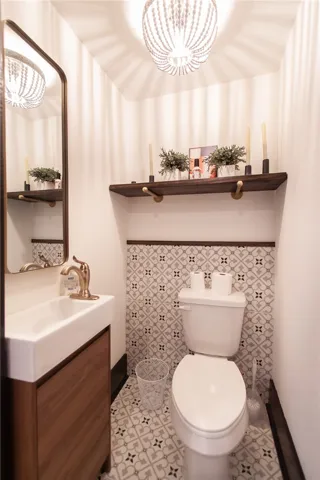 This powder room features elegant tile work and a stylish vanity, perfect for guests.