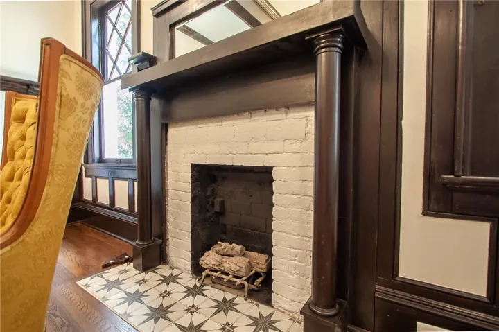 This living area features rich wood accents and a captivating fireplace, perfect for cozy evenings.