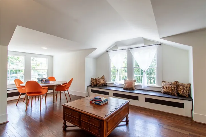 Bright and airy living space with rich hardwood floors and a charming window seat.