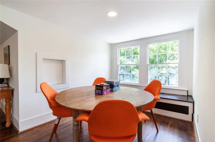 This bright dining area features ample natural light, creating an inviting space for gatherings.