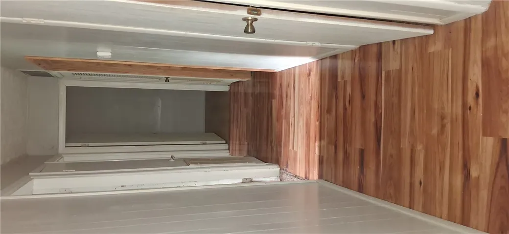 A well-maintained hallway with gleaming hardwood floors connects various rooms, offering a clear passage.