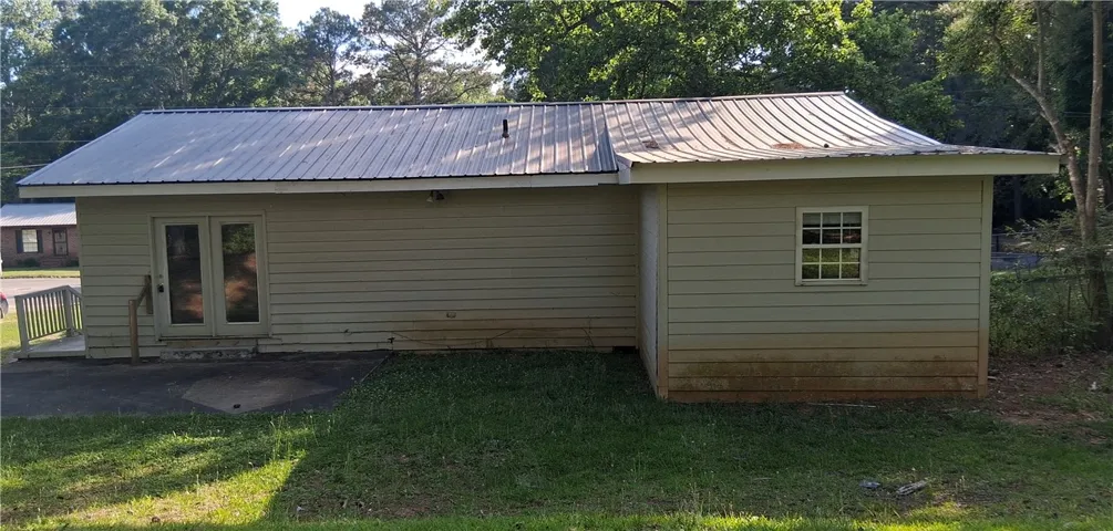 This structure features practical siding and a durable metal roof, providing a functional backyard addition.